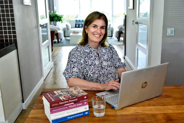 Placeholder for Esther Shaya working with archival documents